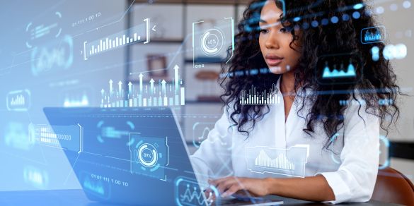 Young woman looking at computer with analytic holograms over